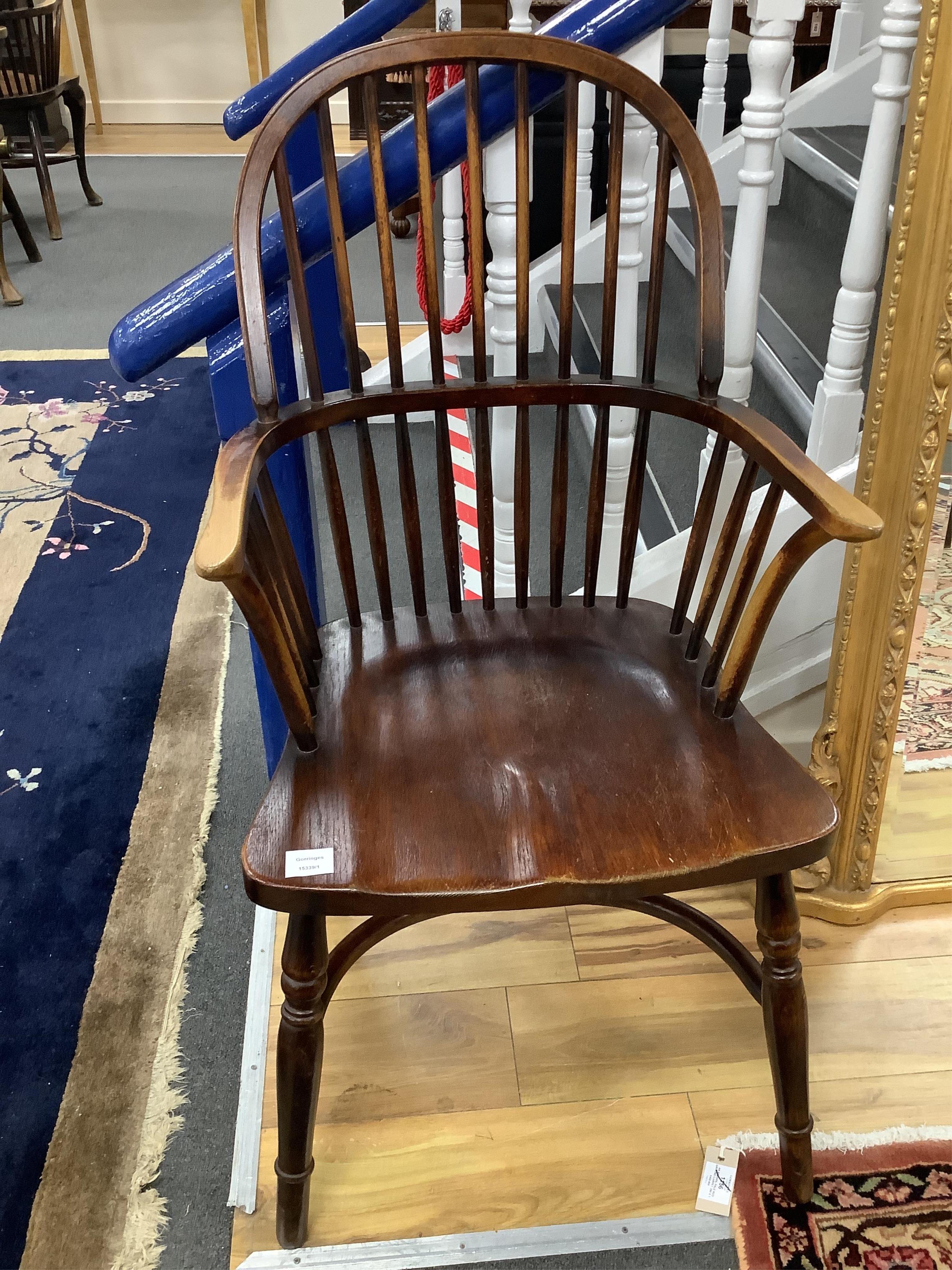 An early 20th century Windsor comb back armchair, width 53cm, depth 48cm, height 101cm. Condition - fair